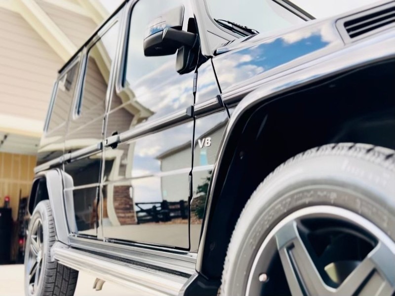 Perfect reflection on the black G-Wagon after 4-step paint correction and 5-year ceramic coating, showcasing a glossy, mirror-like finish with superior protection against scratches and environmental damage