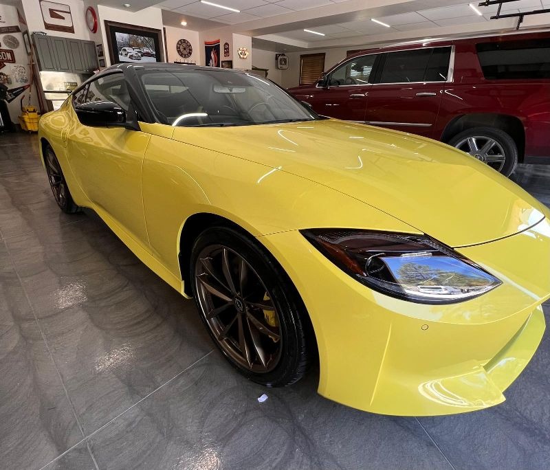 ellow Nissan Z after ceramic coating, paint sealant application, and polishing, showcasing a vibrant, glossy finish with enhanced protection against scratches, contaminants, and water spots for a long-lasting, high-shine look