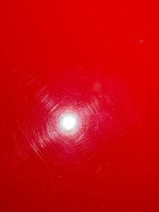 Before paint restoration: Vehicle surface showing visible swirl marks and imperfections, with faded and scratched paint, in need of professional paint correction to restore its smooth, flawless finish