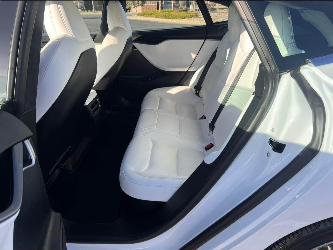 Reconditioned and restored white leather seats in a luxury Tesla Model S, expertly cleaned, conditioned, and protected for a fresh, smooth texture and long-lasting, luxurious appearance after professional detailing