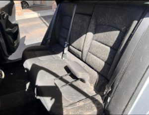 Before cleaning: Interior showing visible pet hair on seats, upholstery, and floor mats, in need of thorough removal to restore a clean, hair-free environment