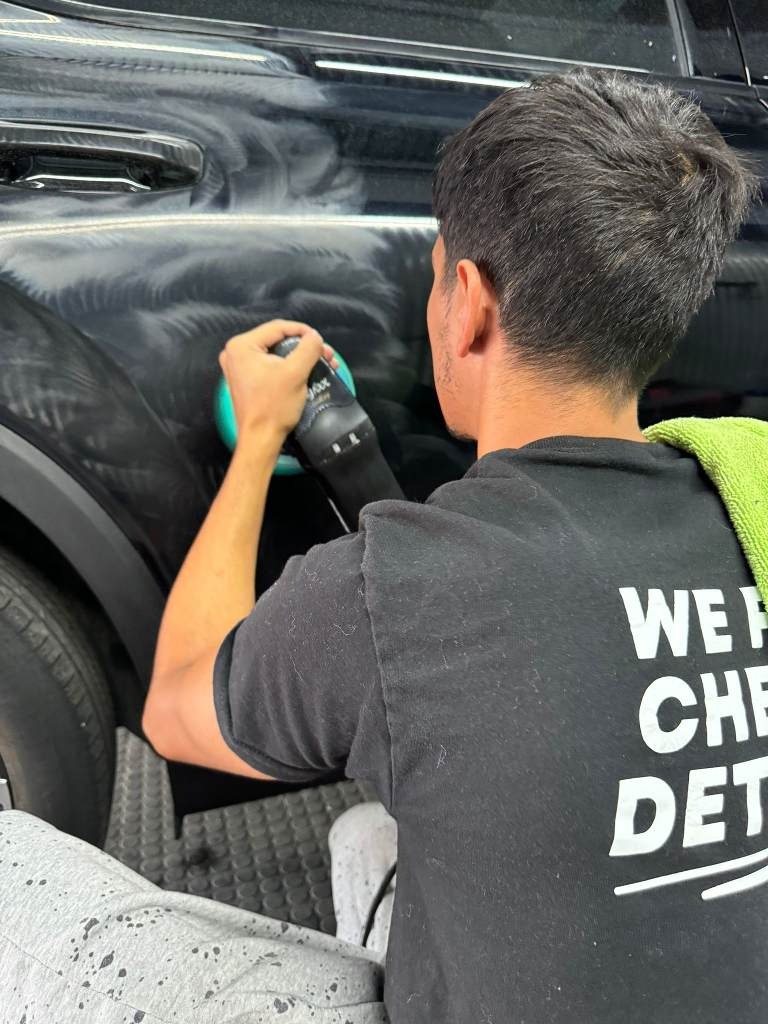 Expert paint correction in progress, as the technician removes scratches and swirl marks from the vehicle's surface, restoring a smooth, flawless finish with professional-grade tools for a like-new appearance